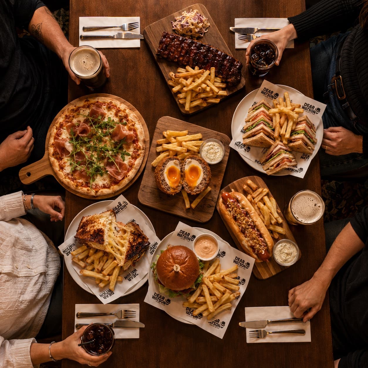 A Dear Watson table filled with food and drinks for sharing
